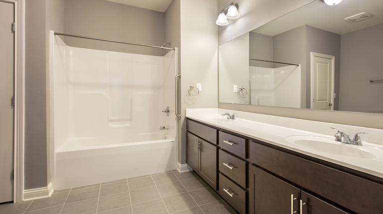 Bathroom vanity with double sink and tub shower